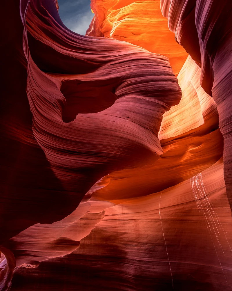 A captivating view of Antelope Canyon showcasing its stunning rock formations in vibrant hues of red and orange, highlighting the intricate textures and patterns carved by erosion.