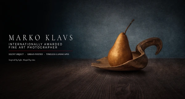 A pear resting on a wooden spoon against a dark background in fine art photography by Marko Klavs.