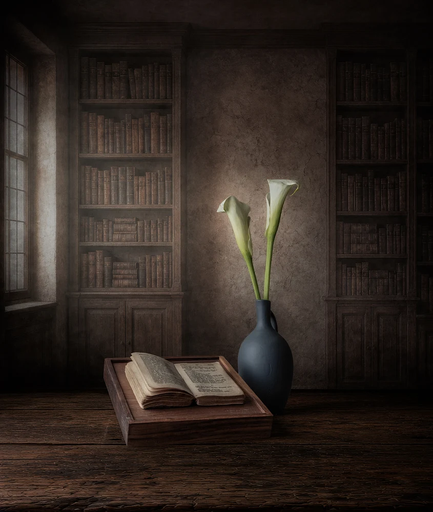 The Silent Bloom by Marko Klavs, a fine art still life photograph of two white calla lilies beside an open antique book in a timeless historic library, illuminated by soft window light.