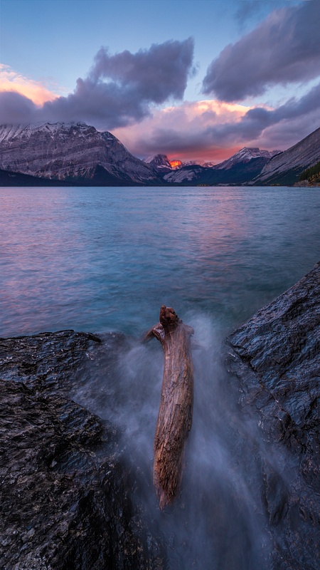 Water Splashing Log in Lake with Sunrise