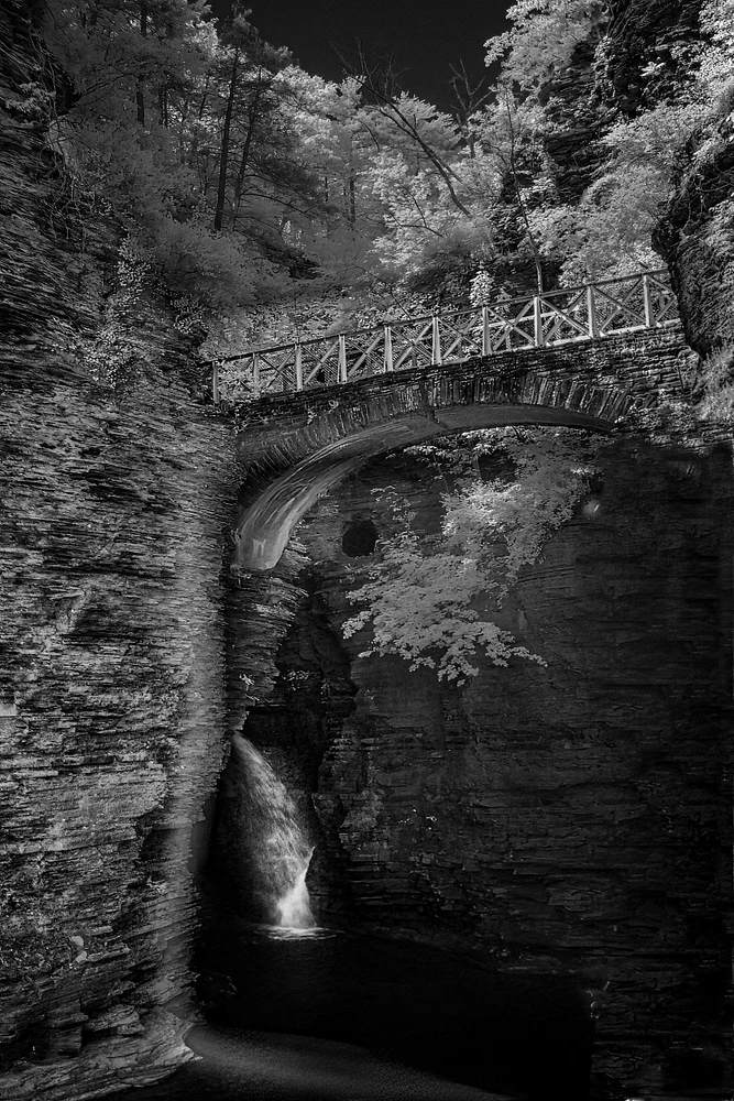Enigmatic Stone Bridge Over Cascading Waters