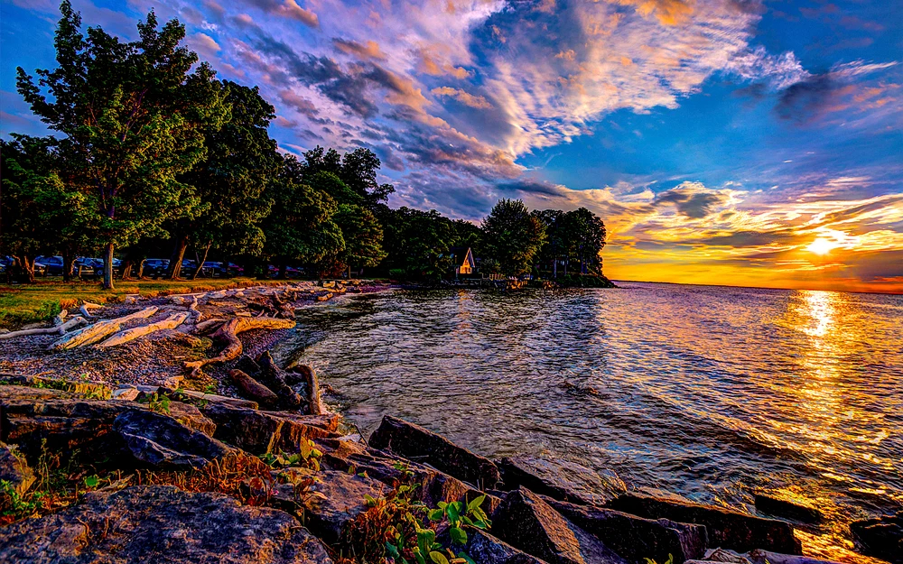 Vibrant Sunset Over Tranquil Lakeside Shoreline