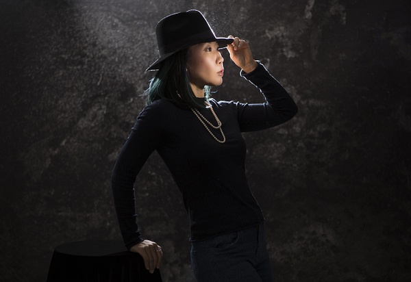Asian woman with black hat by Rick Friedman - Rick & Rick Photo Workshops 