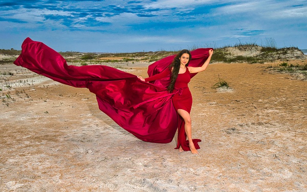 Model on the beach in flowing red dress - Rick Friedman Photography