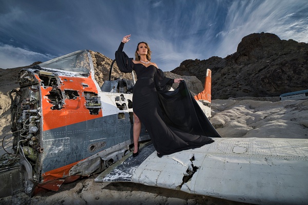 Model in black gown on wing of crashed WW II plane at Nelson Ghost Town , NV   sign by Rick Friedman - Models - Rick Friedman Photography