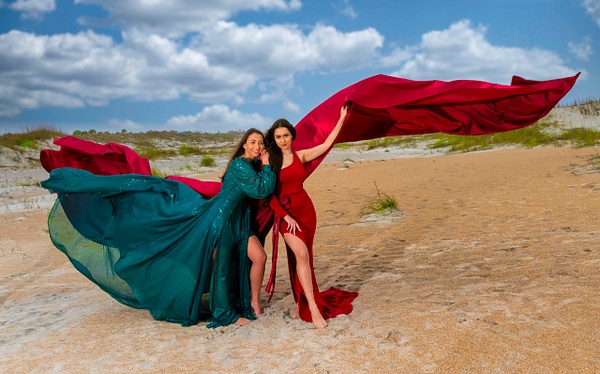 models in flowing green and red dresses on  beach - Rick Friedman Photography