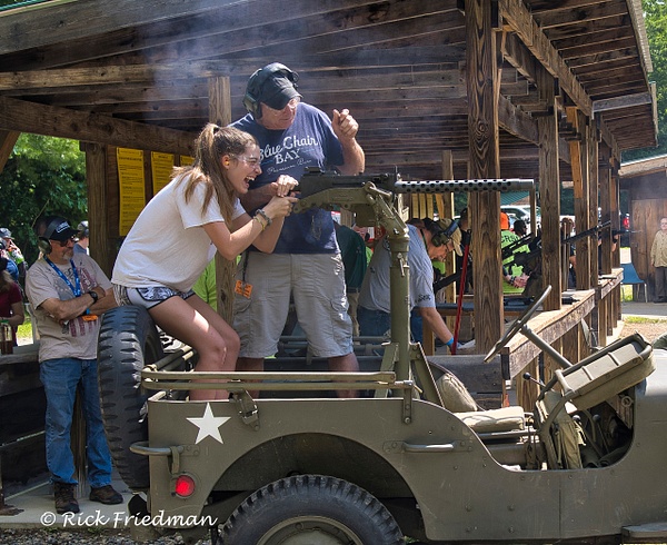 Teenage girl firing 50 caliber machine gun  on  1949 Jeep  at NH Republican  Party fund raiser by Rick Friedman - Rick Friedman Photography