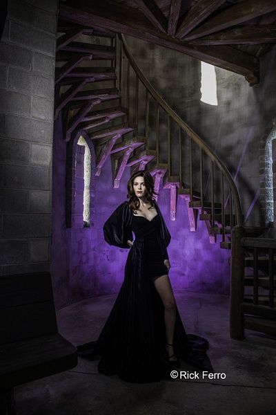 model in black flowing dress in from of circular stairs with purple light by Rick Ferro - Rick & Rick Photo Workshops 