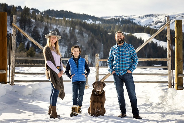 family with dog  in front of fence  in snow - Flo McCall Photography 
