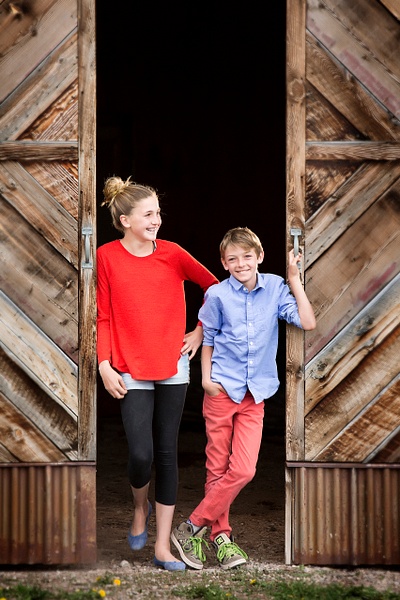 sibling in barn door - Flo McCall Photography