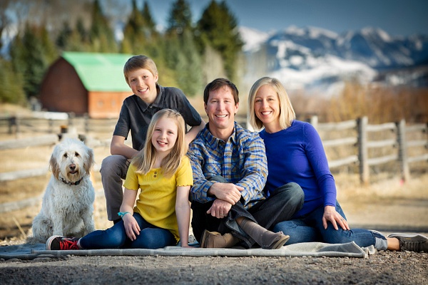 Family portrait with barn and mountain backdrop - Flo McCall Photography
