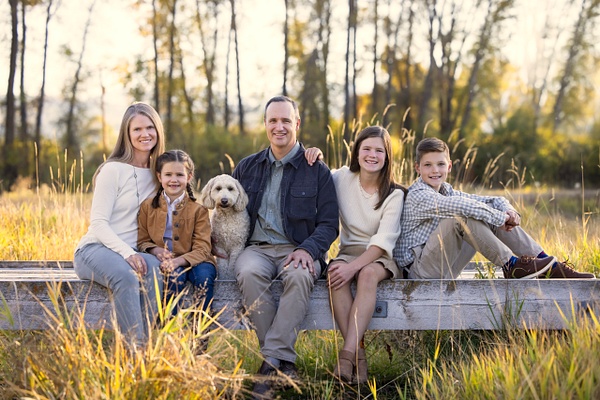 Family on bridge with dog and tall grasses - Flo McCall Photography