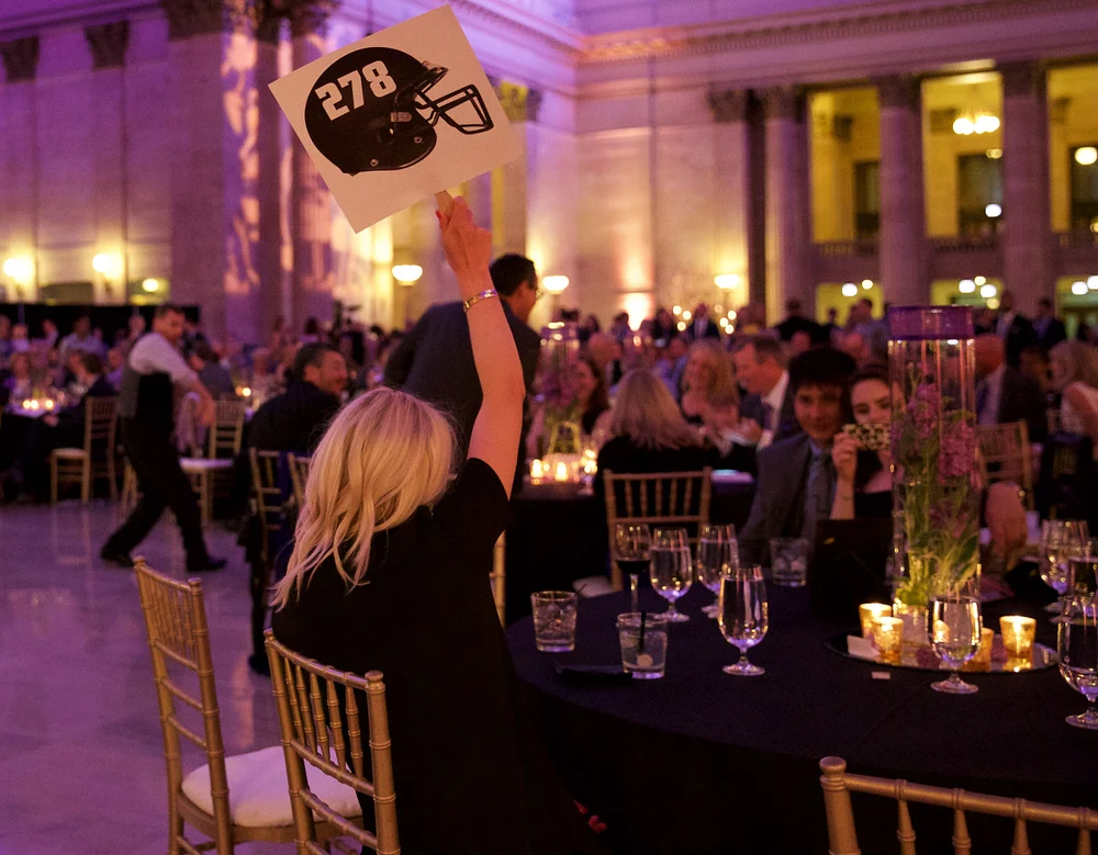 Elegant Charity Gala with Auction Paddle Raised