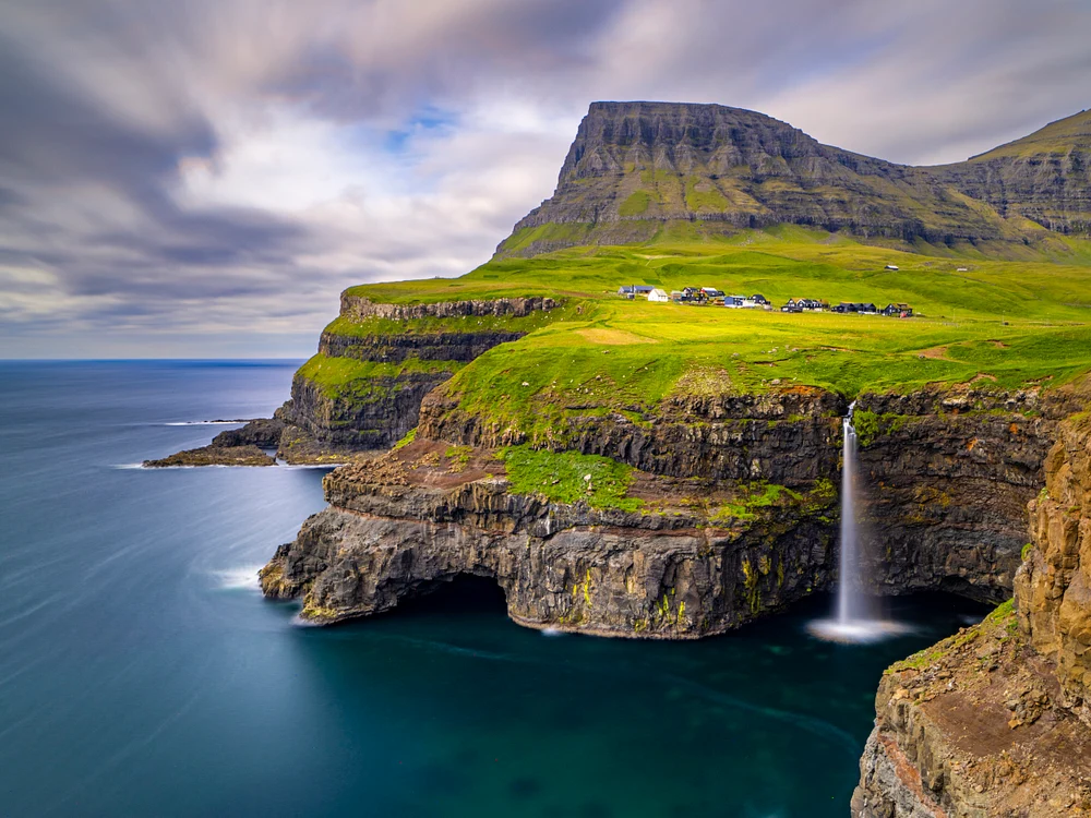Majestic Waterfall Cascading into the Sea in the Faroe Islands