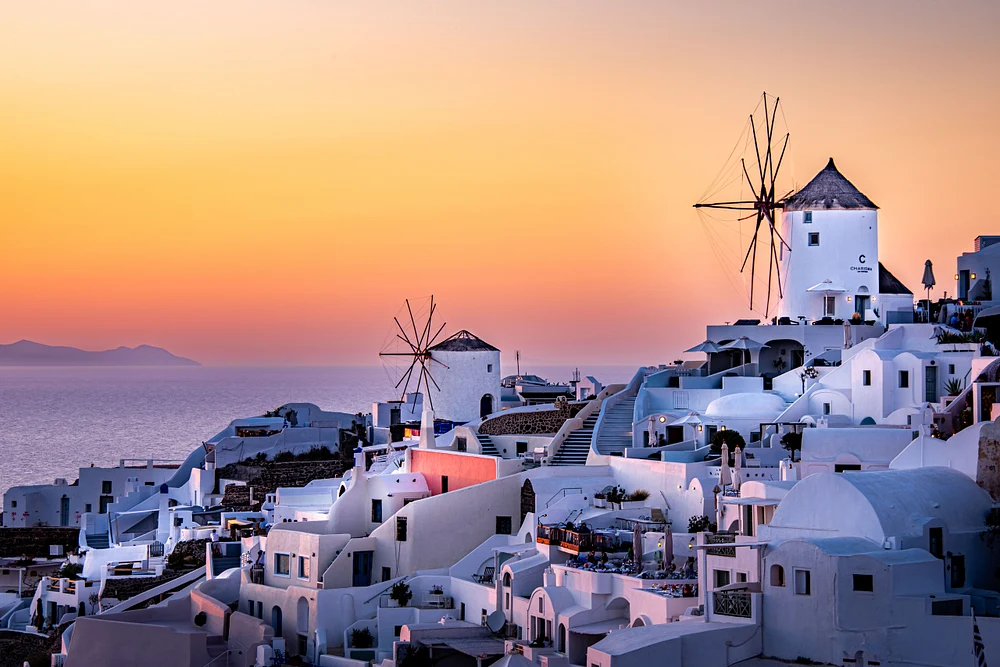 Serene Sunset Over Oia Windmills in Santorini