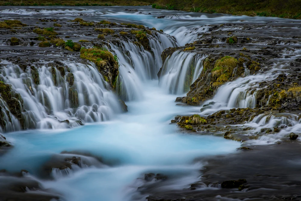 Bruarfoss Waterfall: Ethereal Blue Waters Cascade Through Volcanic Rock in Iceland