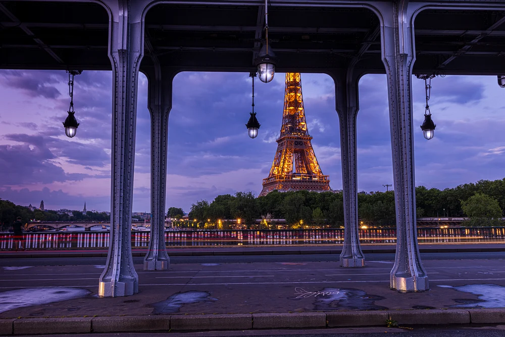 Illuminated Eiffel Tower Through Bir-Hakeim Bridge at Twilight, Paris