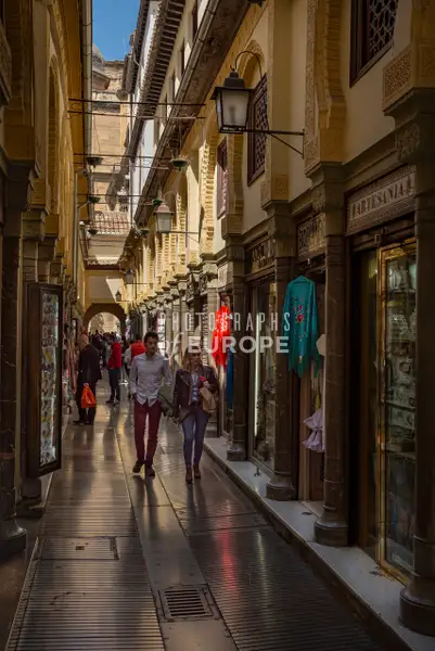 Narrow-shopping-arcade-Granada-Spain by Neil Lamont