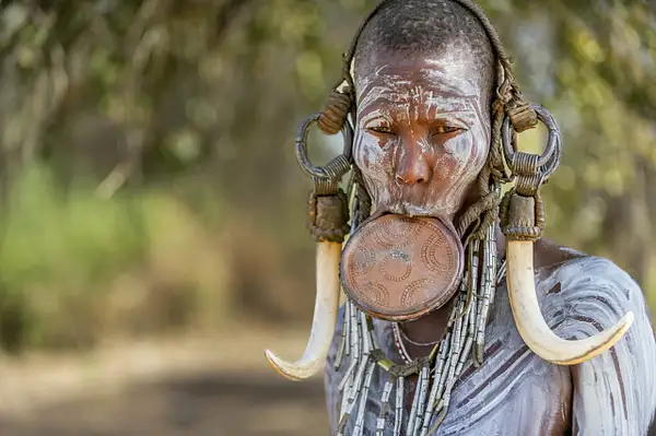 Woman of the Mursi tribe wearing a clay lip plate,...