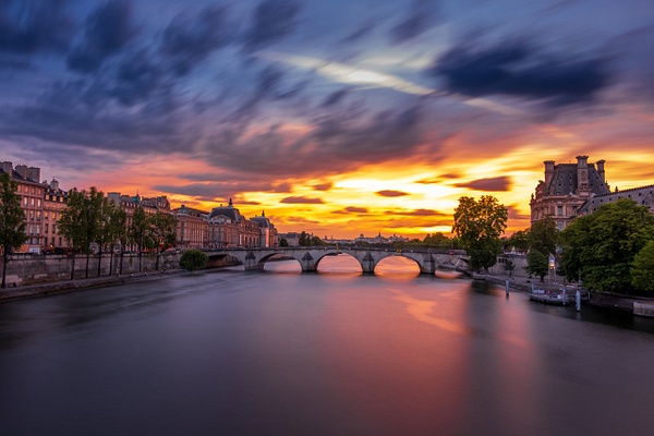 Breathtaking Sunset Over the Seine River in Paris with Pont Des Arts and the Louvre
