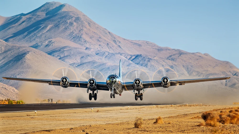 B-29 Bomber Ascending Over Majestic Mountain Range