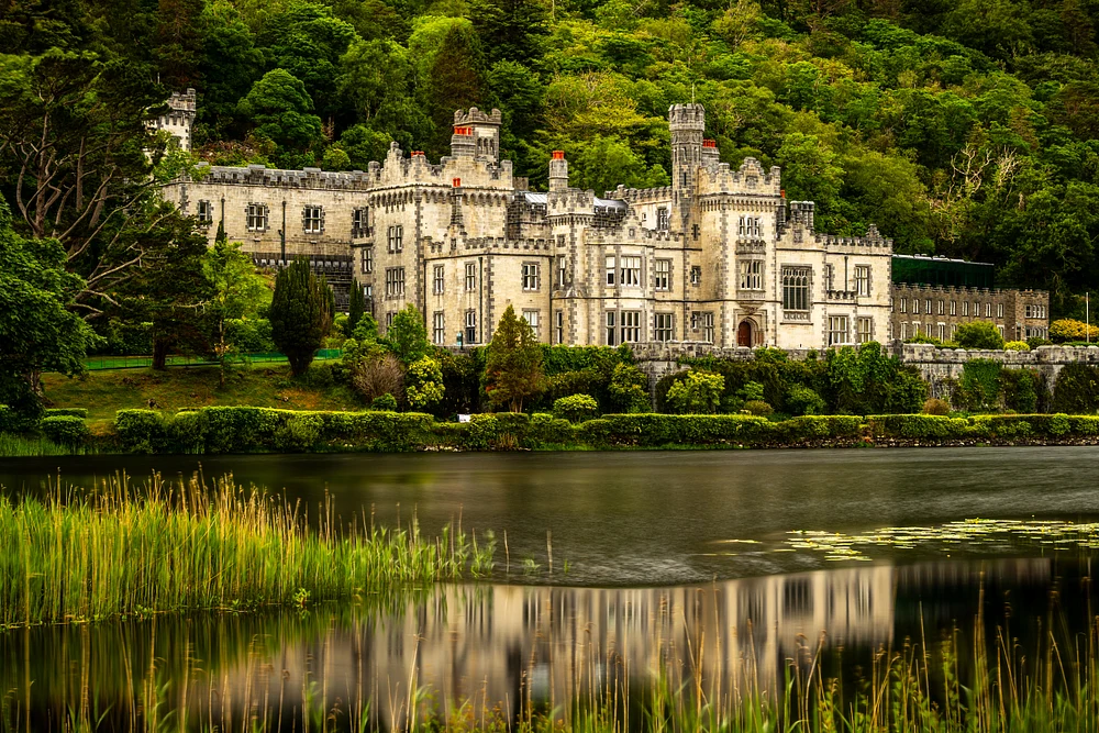 Stunning View of a Historic Castle in Ireland Surrounded by Lush Greenery