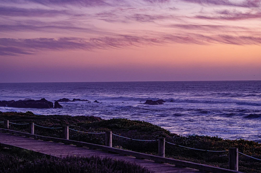 Serene Lavender Beach Sunset Over Ocean Waves