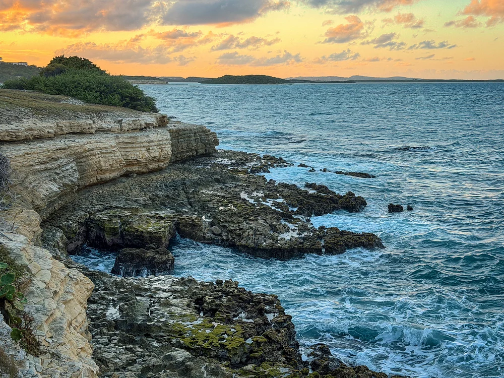 Breathtaking Coastal Sunset Over Rocky Shoreline