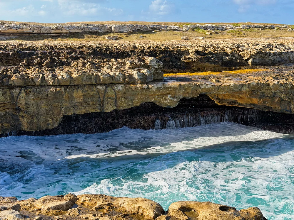Majestic Coastal Cave with Turquoise Waters