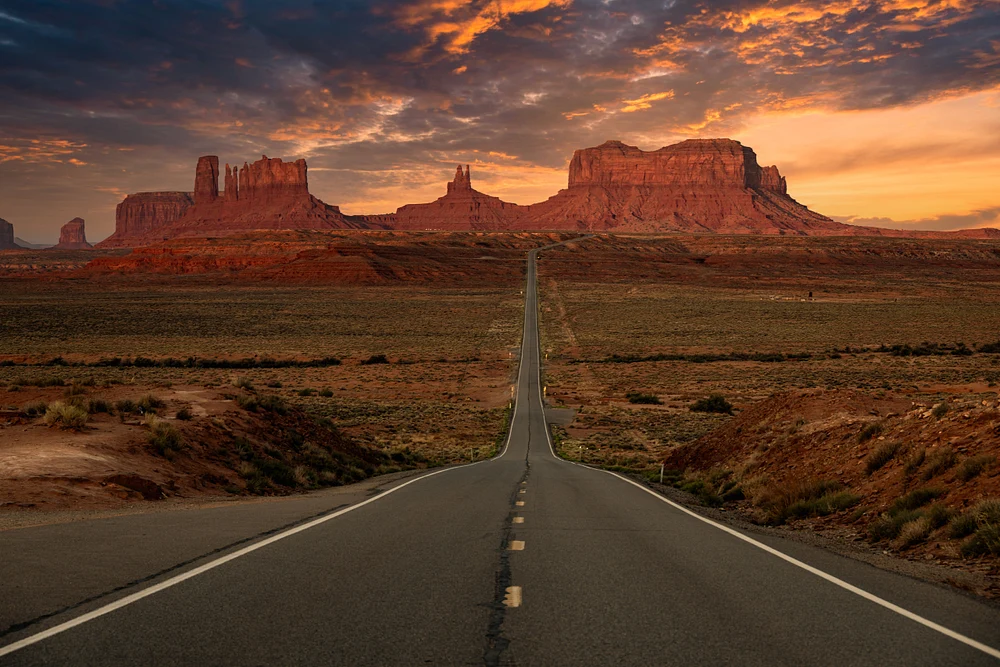 Endless Road Leading to Monument Valley's Majestic Peaks
