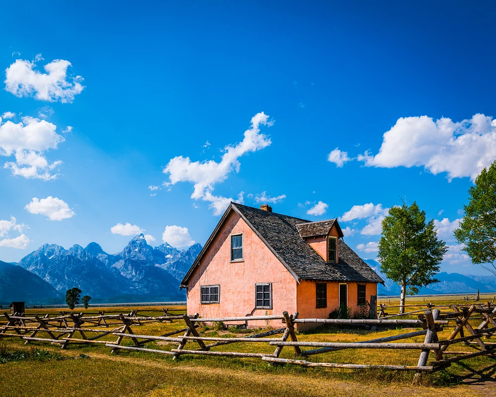 Charming Pink House Amidst Majestic Mountains