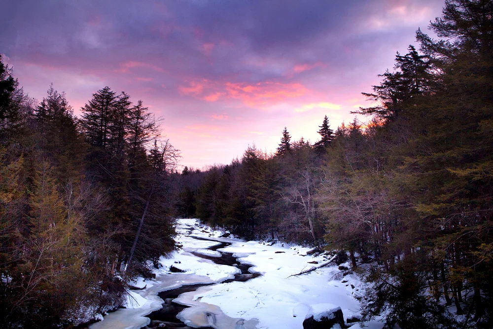 Enchanting Winter Stream Under Colorful Skies