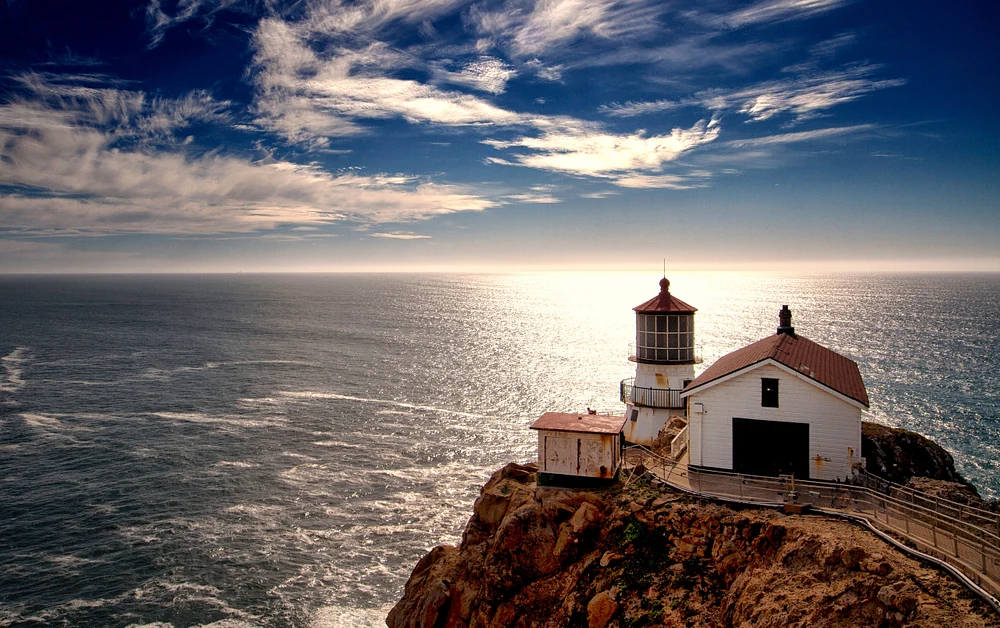 Radiant Lighthouse Overlooking Ocean Waves