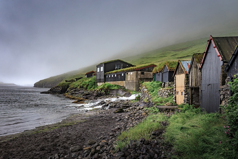 Fogbound Bour Boathouses Along a Faroe Island Shore