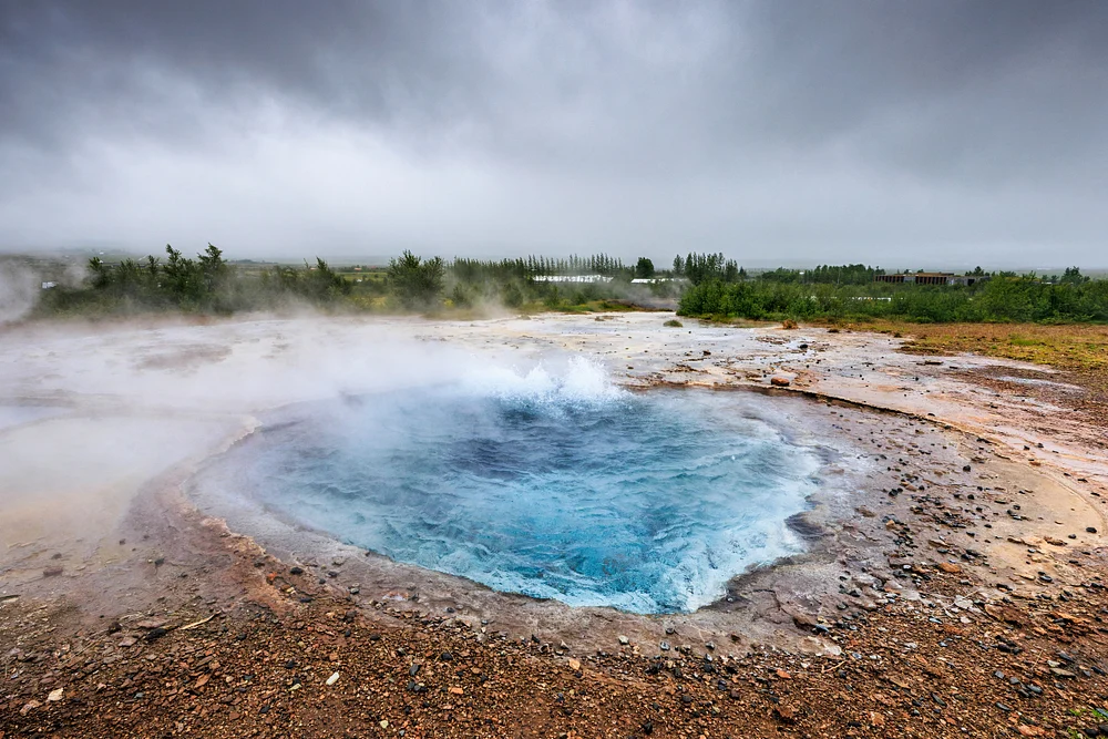 Icelandic Geysir Thermal Pool Beneath a Stormy Sky