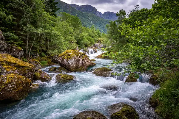 Emerald Torrent Beneath Norway’s Bondhusvatnet Peaks...