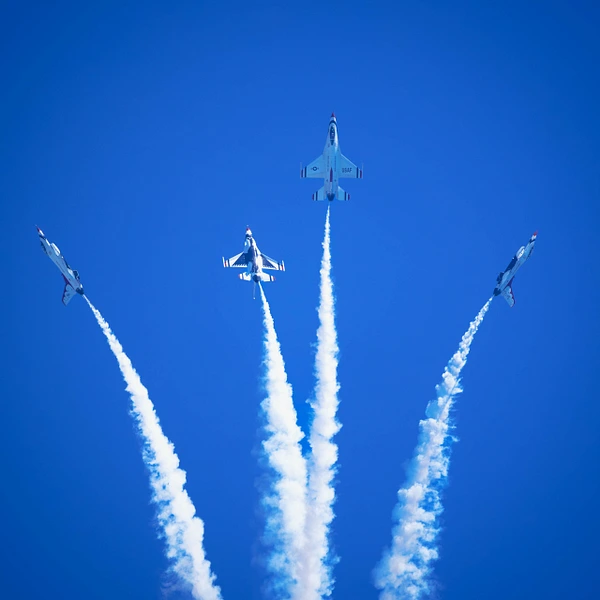 USAF Thunderbirds performing an aerial display over Ft. Lauderdale with smoke trails in the sky.