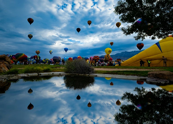 Vibrant hot air balloons fill the sky at the Albuquerque Balloon Fiesta.