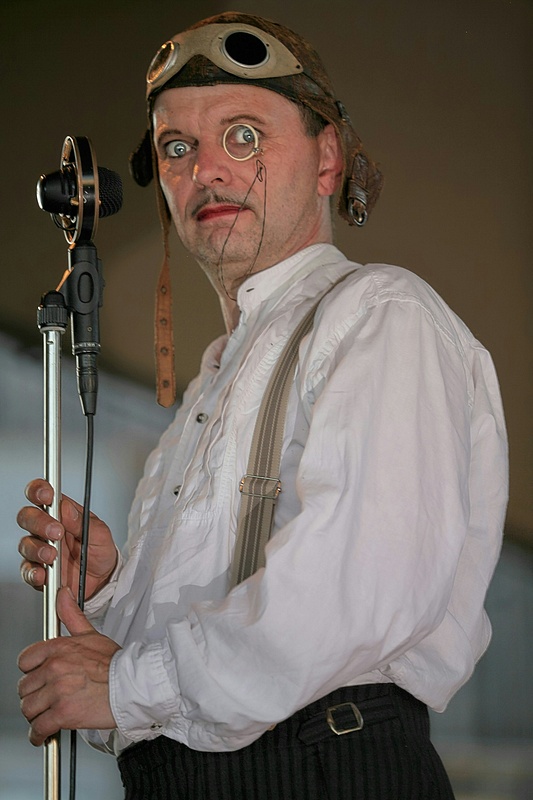 Goggle-Wearing Vaudeville Performer Beside Vintage Microphone