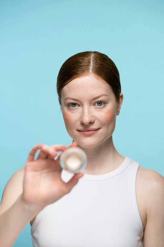 Woman Holding Skincare Container in Clean Beauty Portrait