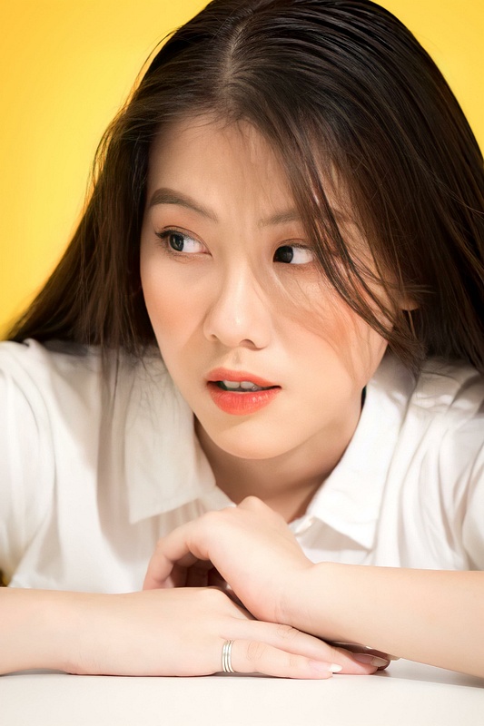 Expressive Asian Woman Portrait with Warm Studio Light